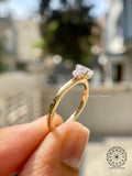Round side diamonds flanking the oval center stone for a refined three stone look