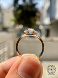 Three stone oval diamond ring featuring a sleek straight shank design