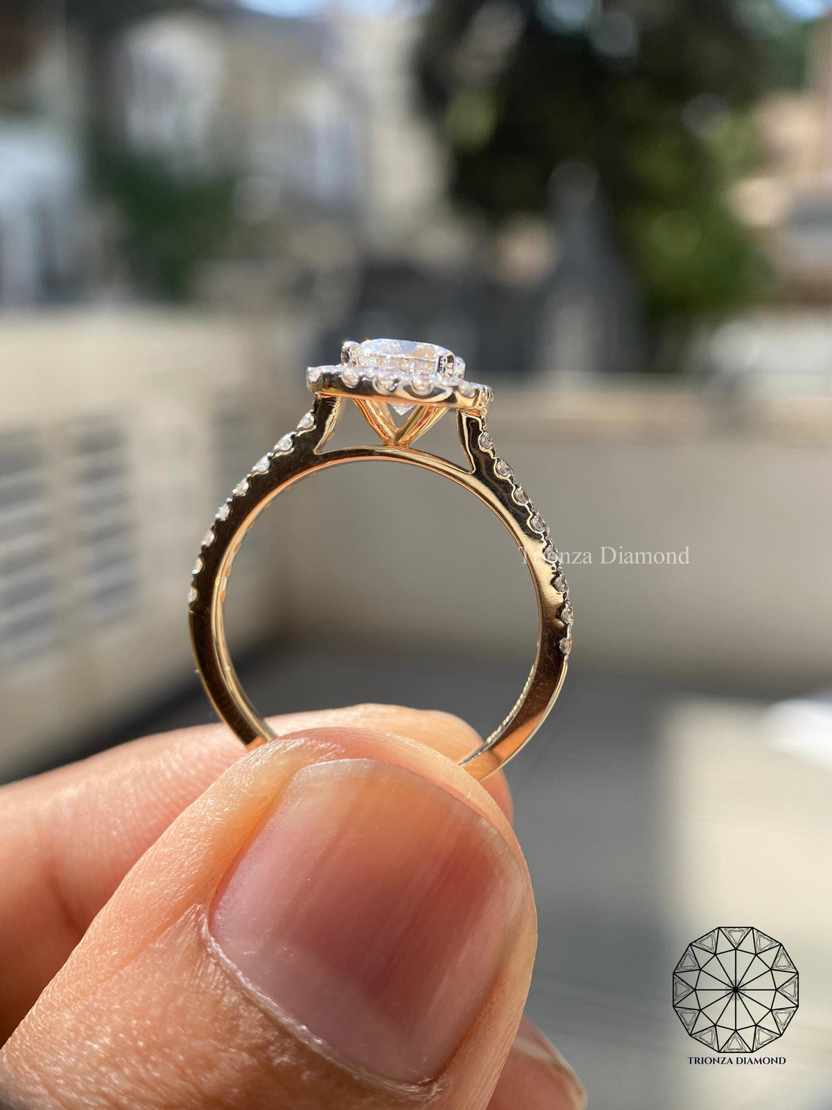 Two-tone gold engagement ring highlighting the pave accents around the halo
