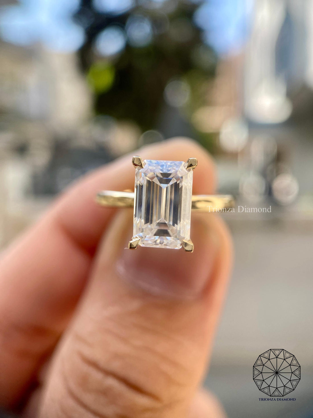 Emerald cut lab diamond engagement ring in 14K yellow gold with a classic solitaire setting
