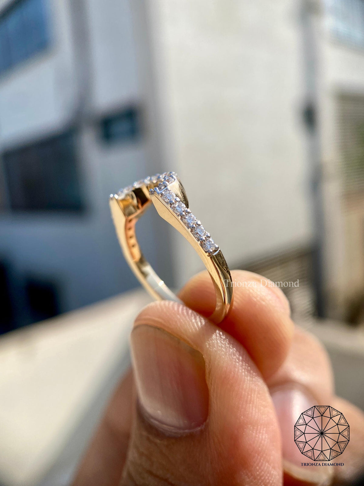 Woman wearing the pave diamond stacking ring alongside a low setting engagement ring
