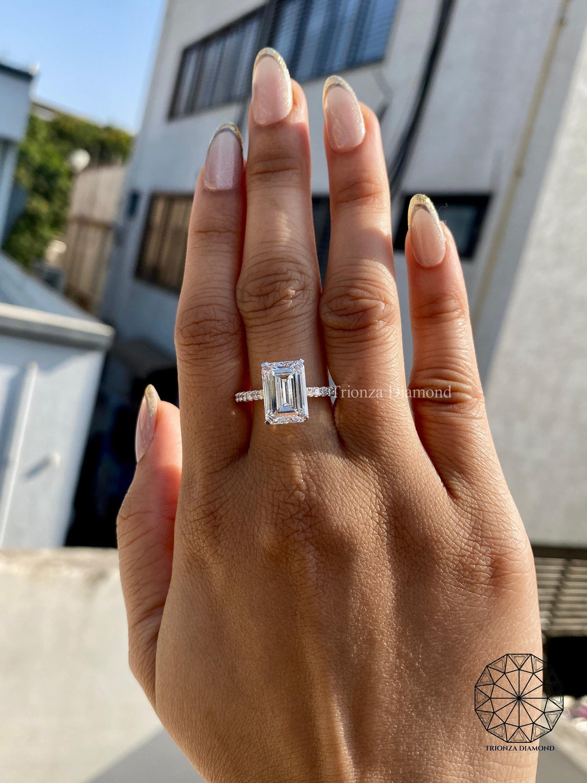 Woman wearing the emerald cut diamond solitaire ring for an elegant everyday look