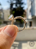 14k gold bridal ring set featuring a pear cut center stone and radiant cut accents