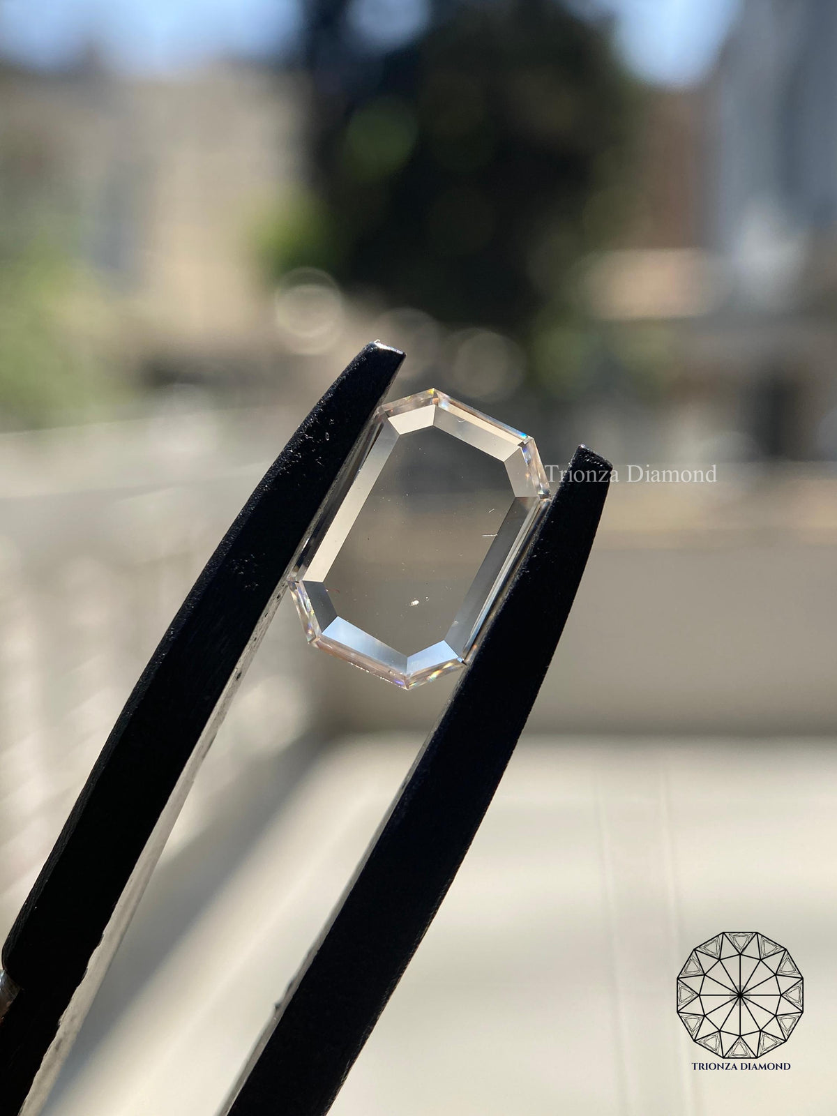 Emerald rose cut CVD diamond displayed to show its unique faceted surface