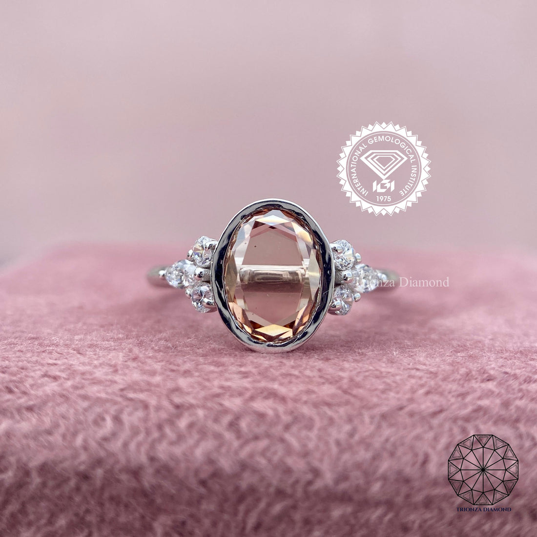 Oval rose cut lab grown diamond ring featuring a bezel setting with round and marquise side stones