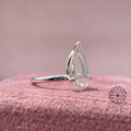 Minimalist drop shape ring crafted with a floating claw setting for a modern bridal look