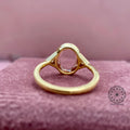 Woman wearing the oval diamond bezel ring, close-up view on her hand