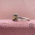 Gold statement ring showcasing the rich brown hue of the emerald cut diamond