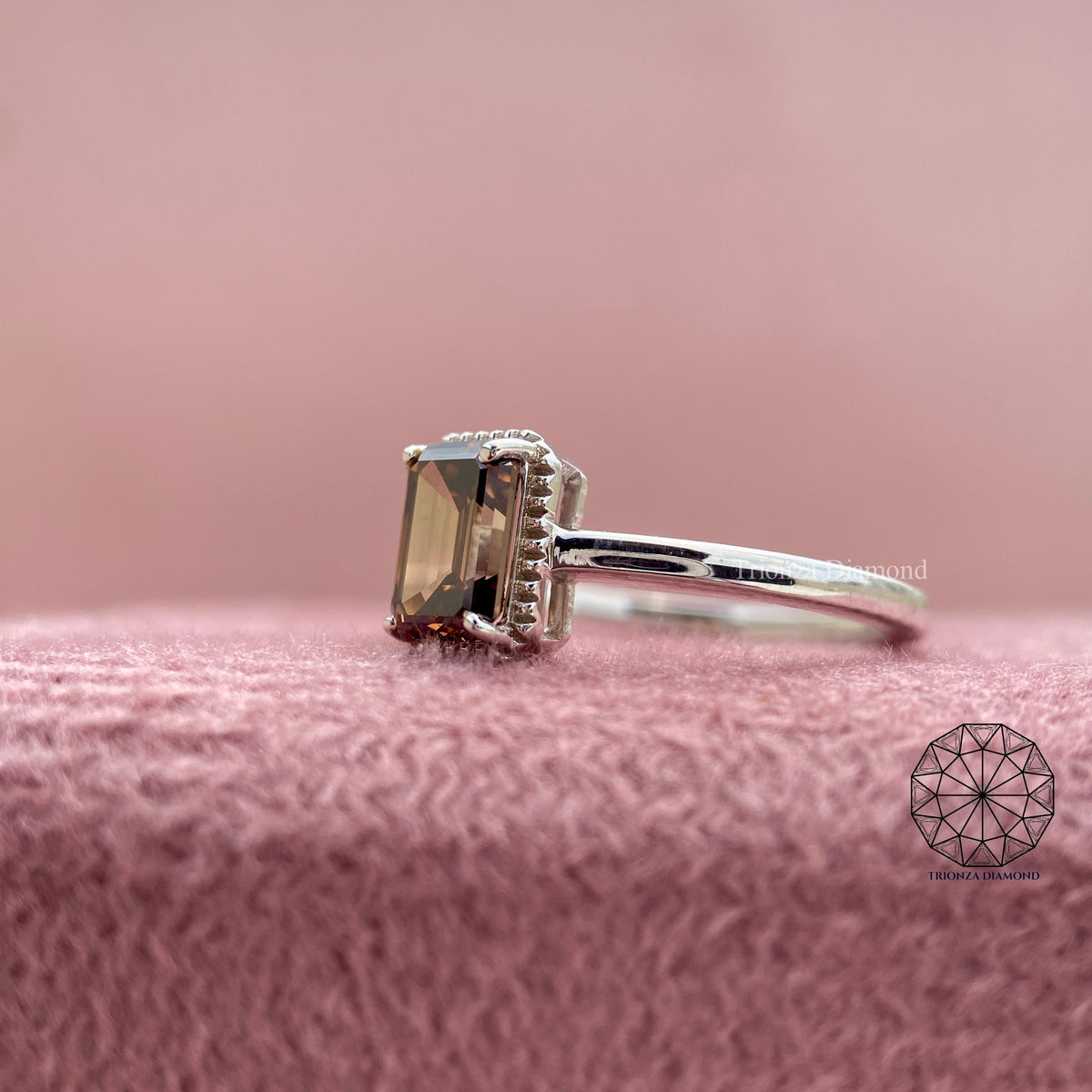 Gold statement ring showcasing the rich brown hue of the emerald cut diamond