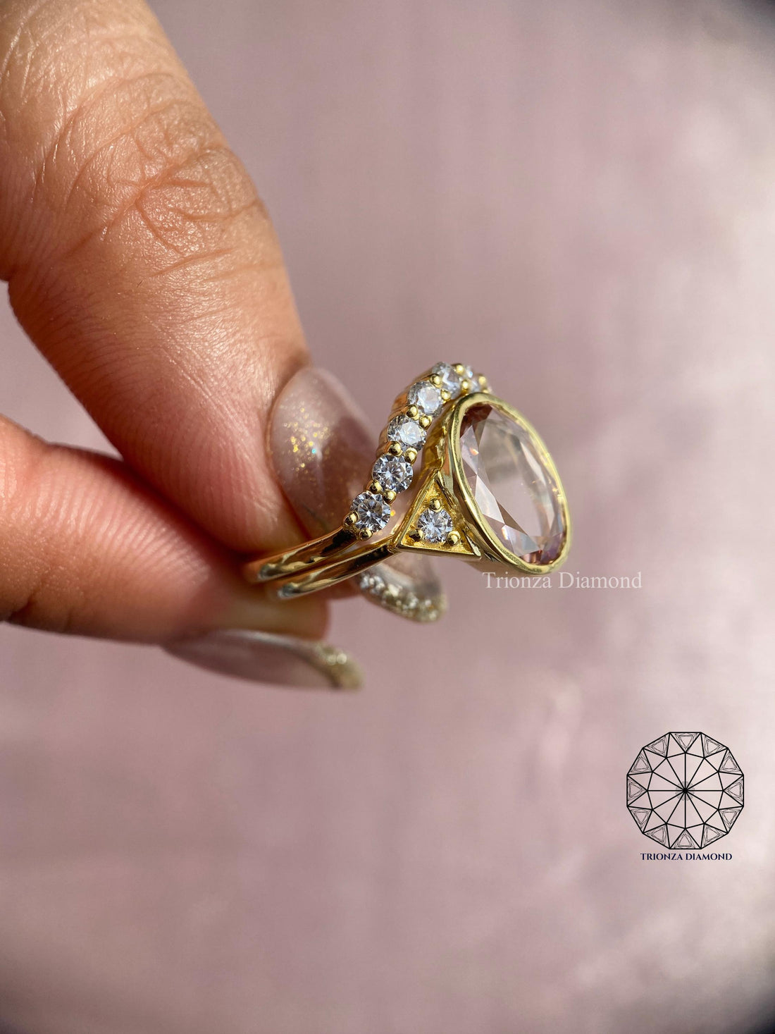 Bezel set oval rose cut diamond ring displayed alongside its curved matching wedding band
