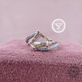Modified trillion rose cut diamond ring with a bypass shank pave setting displayed up close
