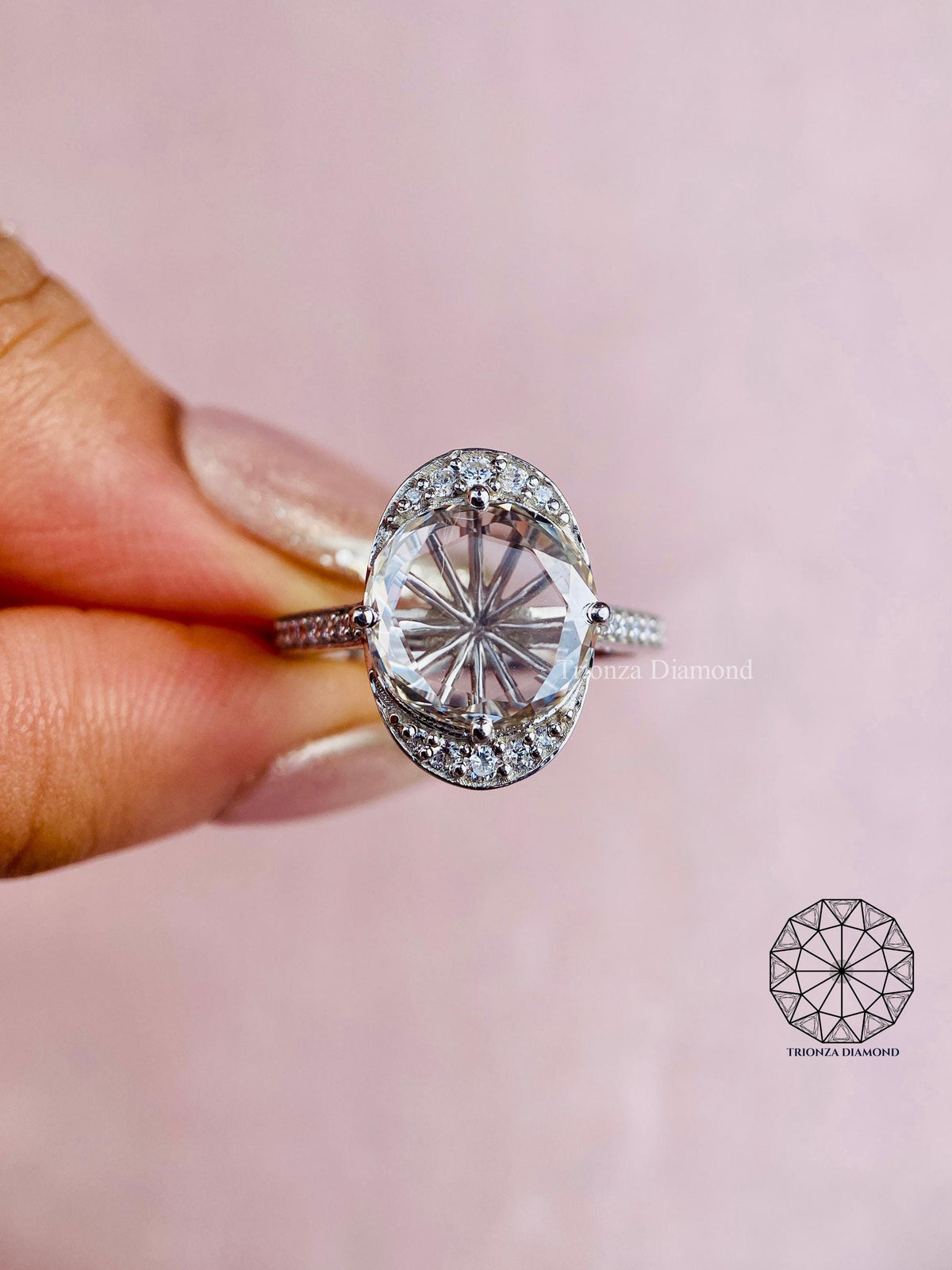 Halo engagement ring showcasing the E/F color and VVS/VS clarity of the center diamond