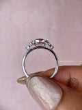 Woman wearing the oval diamond engagement ring, close-up view on her hand