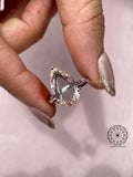 Woman wearing the pear cut diamond engagement ring, close-up view on her hand