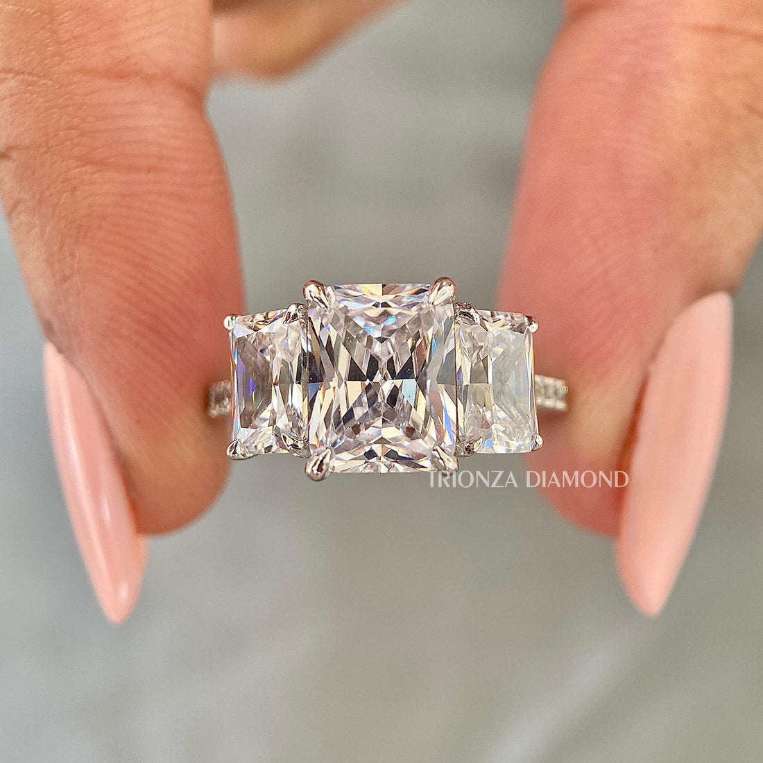 Radiant cut lab grown diamond ring with three stone design and pavé band in 18k white gold