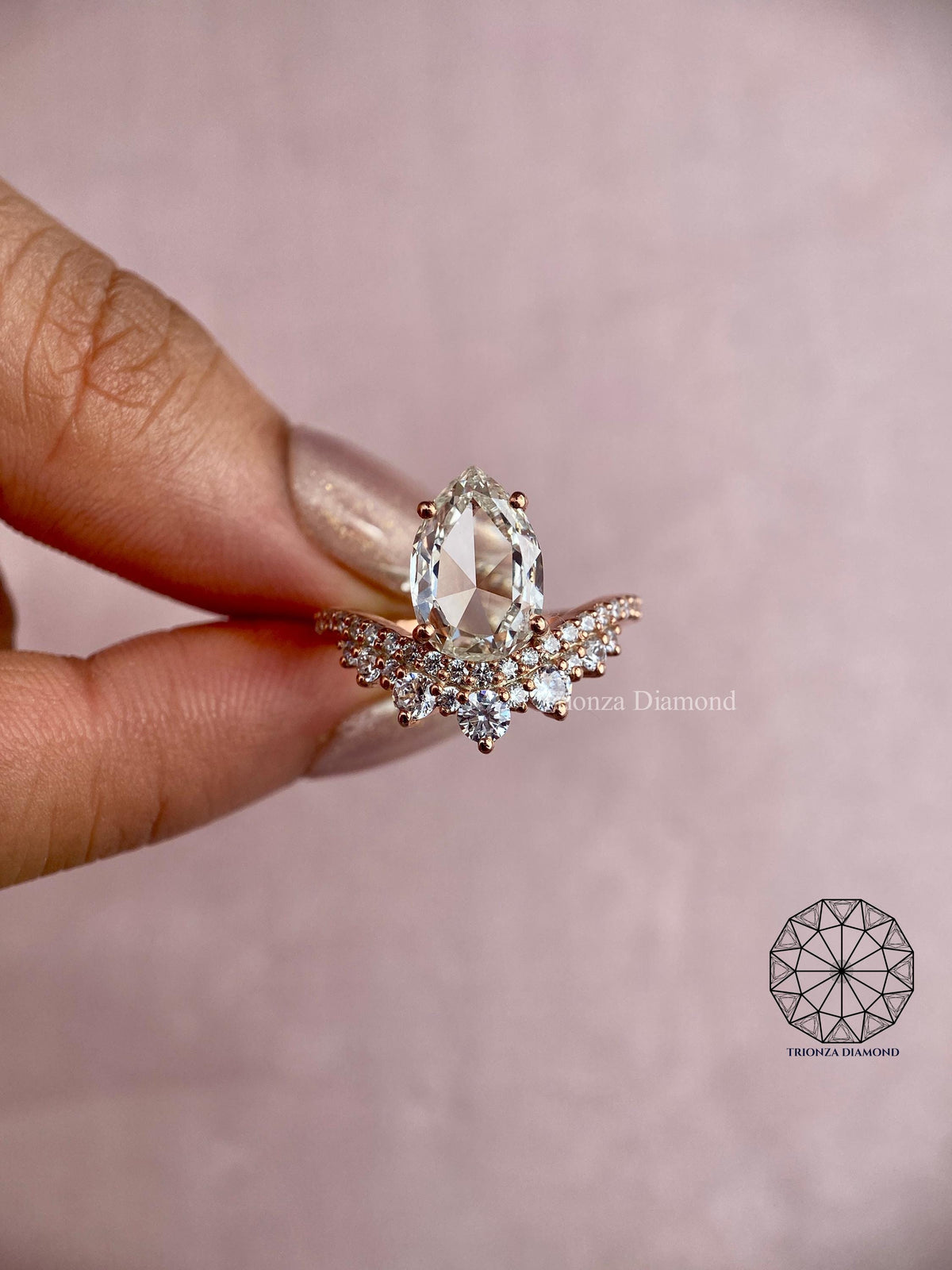 Teardrop diamond engagement ring showing the radiant crown of accent stones around the center stone