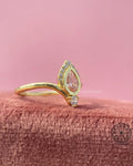 14k solid gold ring featuring a pear shaped orange diamond set in a chevron style band