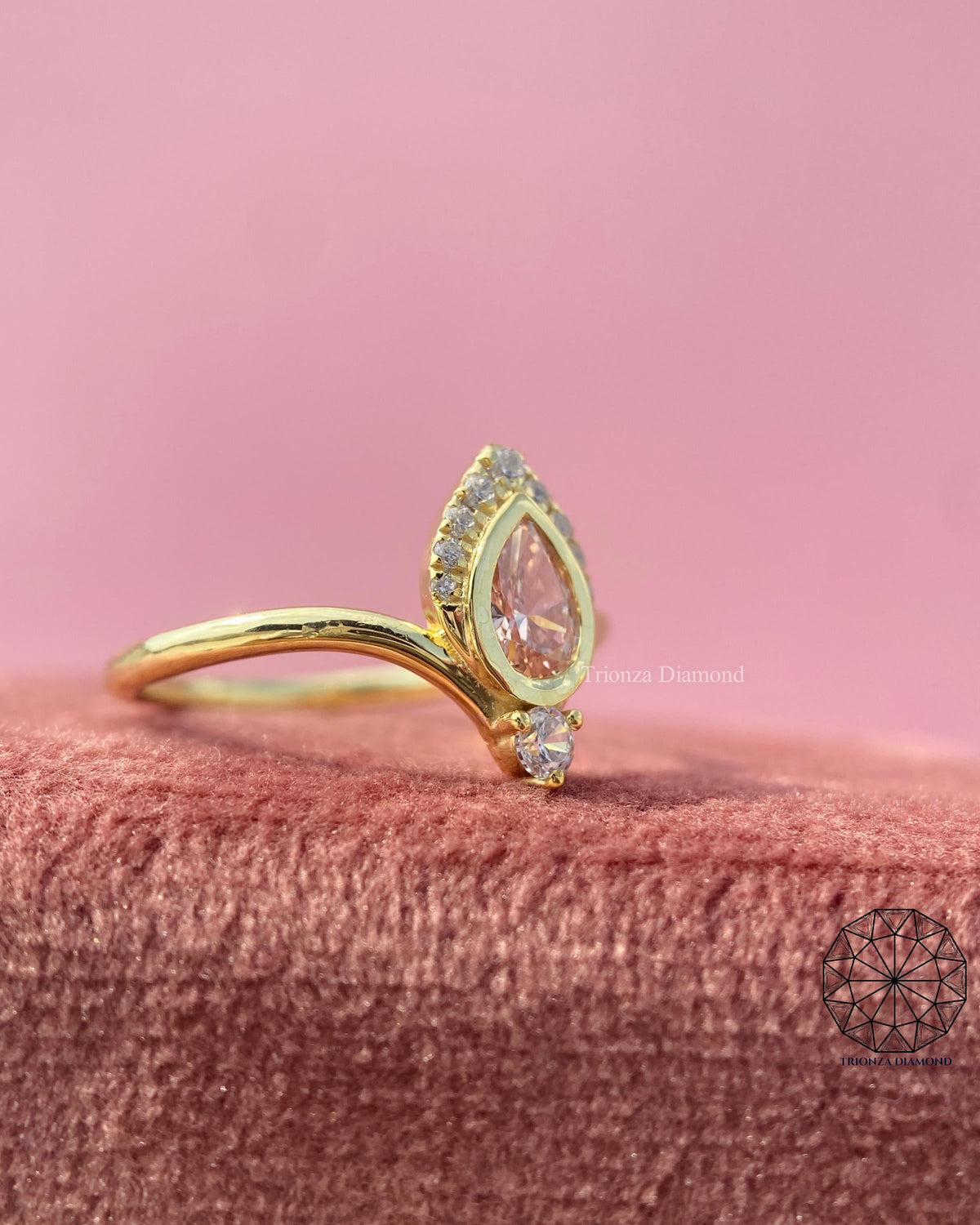 14k solid gold ring featuring a pear shaped orange diamond set in a chevron style band