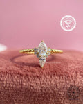 Pear shaped lab grown diamond engagement ring with a twisted 14k gold band design