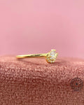 Teardrop engagement ring featuring a 0.15 carat pear cut CVD diamond in yellow gold