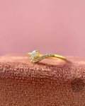 Side view of the 14k yellow gold ring highlighting the pear shaped stone setting