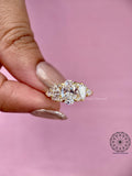 Woman wearing the oval diamond cluster ring, close-up on her hand for scale