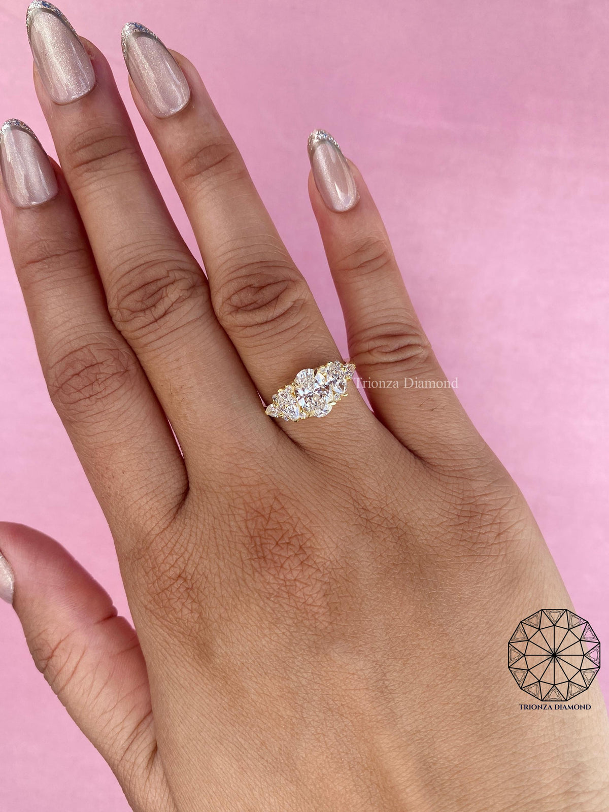 TrionzaDiamond engagement ring crafted with an oval center stone and marquise pear accents