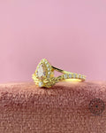 Split shank engagement ring highlighting the leaf branch details along the gold band