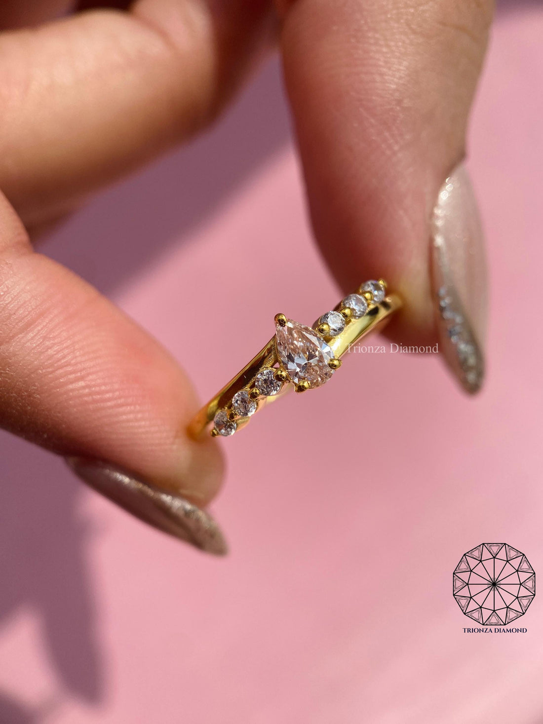 Fancy pink pear diamond engagement ring with a bypass setting crafted in handmade style