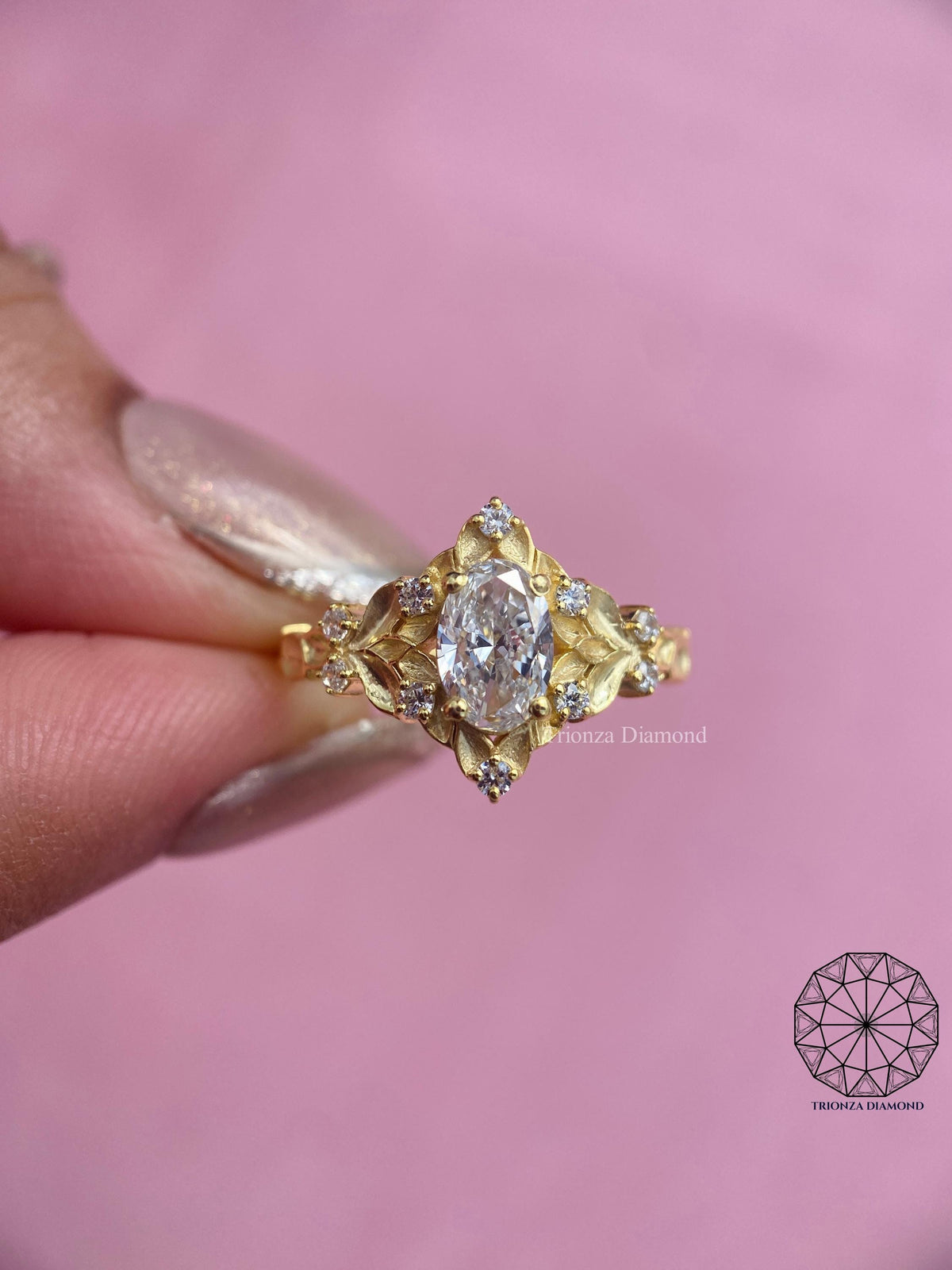 Close-up of the oval diamond secured within the intricate leaf setting