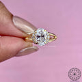Halo setting highlighting the oval solitaire diamond on a split shank band