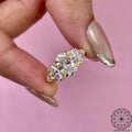 Close-up of the oval cut lab grown diamond set in a three stone trilogy design
