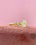 Close-up of the floating bubble diamond design showing the emerald cut center stone and round accent