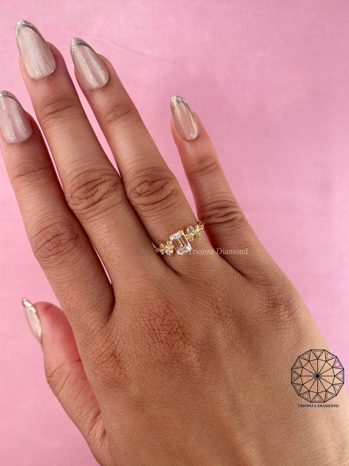 Woman wearing the emerald cut diamond wedding ring, close-up on her hand