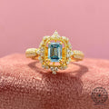 Emerald cut lab grown diamond ring displayed to highlight its blue color and brilliant facets
