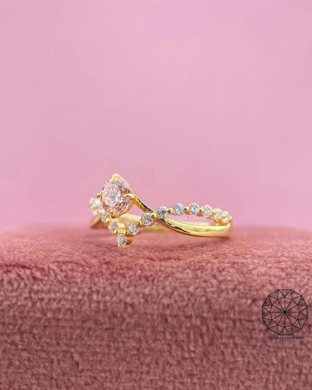 Close-up of the crown style prong setting holding the round pink diamond securely