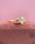 Trilogy ring for her displayed to show the oval diamond and side round pink diamonds in detail