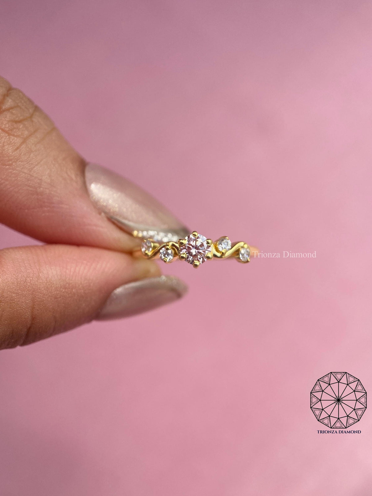 Handcrafted engagement ring showcasing the rich gold tone and blush diamond