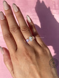 Trilogy ring for her shown from an angle highlighting the brilliance of the oval diamond