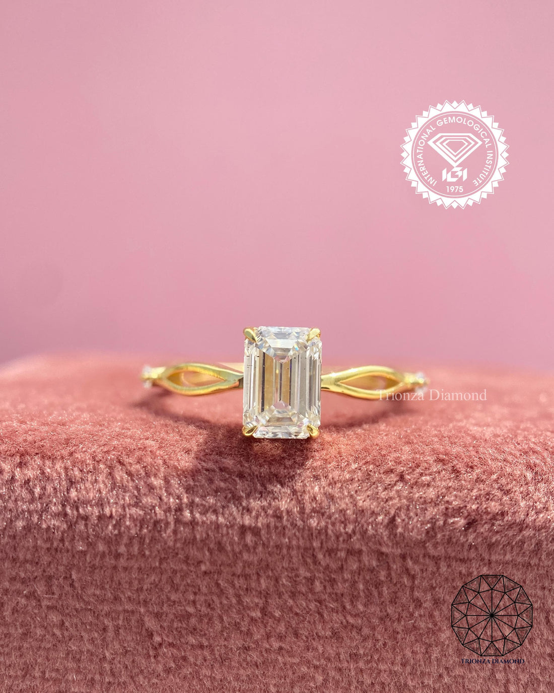 Emerald cut lab grown diamond engagement ring featuring a twisted 14k gold band
