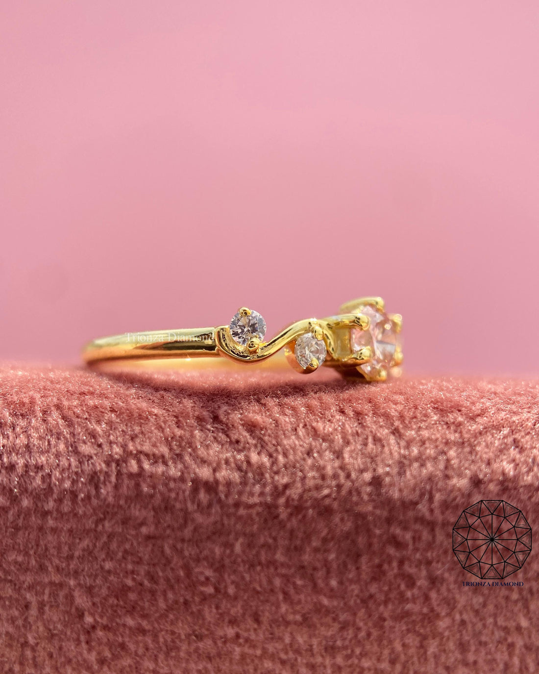 Round pink lab grown diamond ring featuring a swirl band in 14K yellow gold