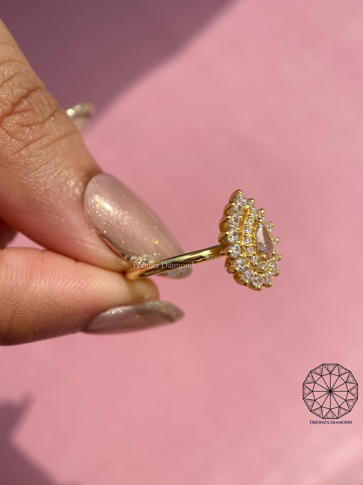 Vintage floral engagement ring designed with dainty details and a pear shaped pink center stone