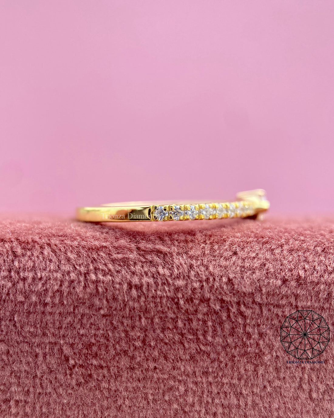 Pink pear cut lab grown diamond ring displayed in an east west dainty setting