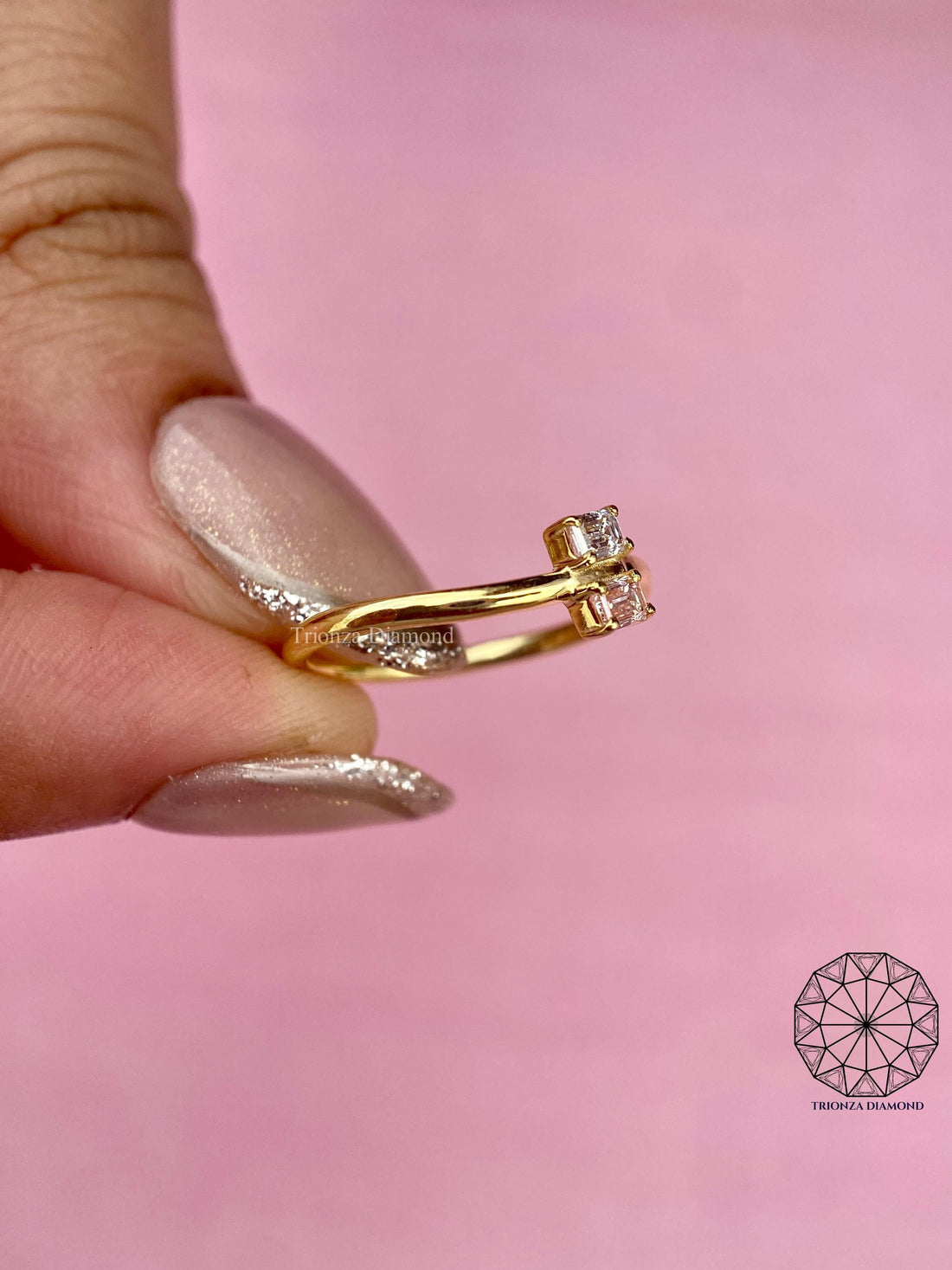 Toi et moi emerald cut ring featuring a fancy vivid pink and a white lab grown diamond