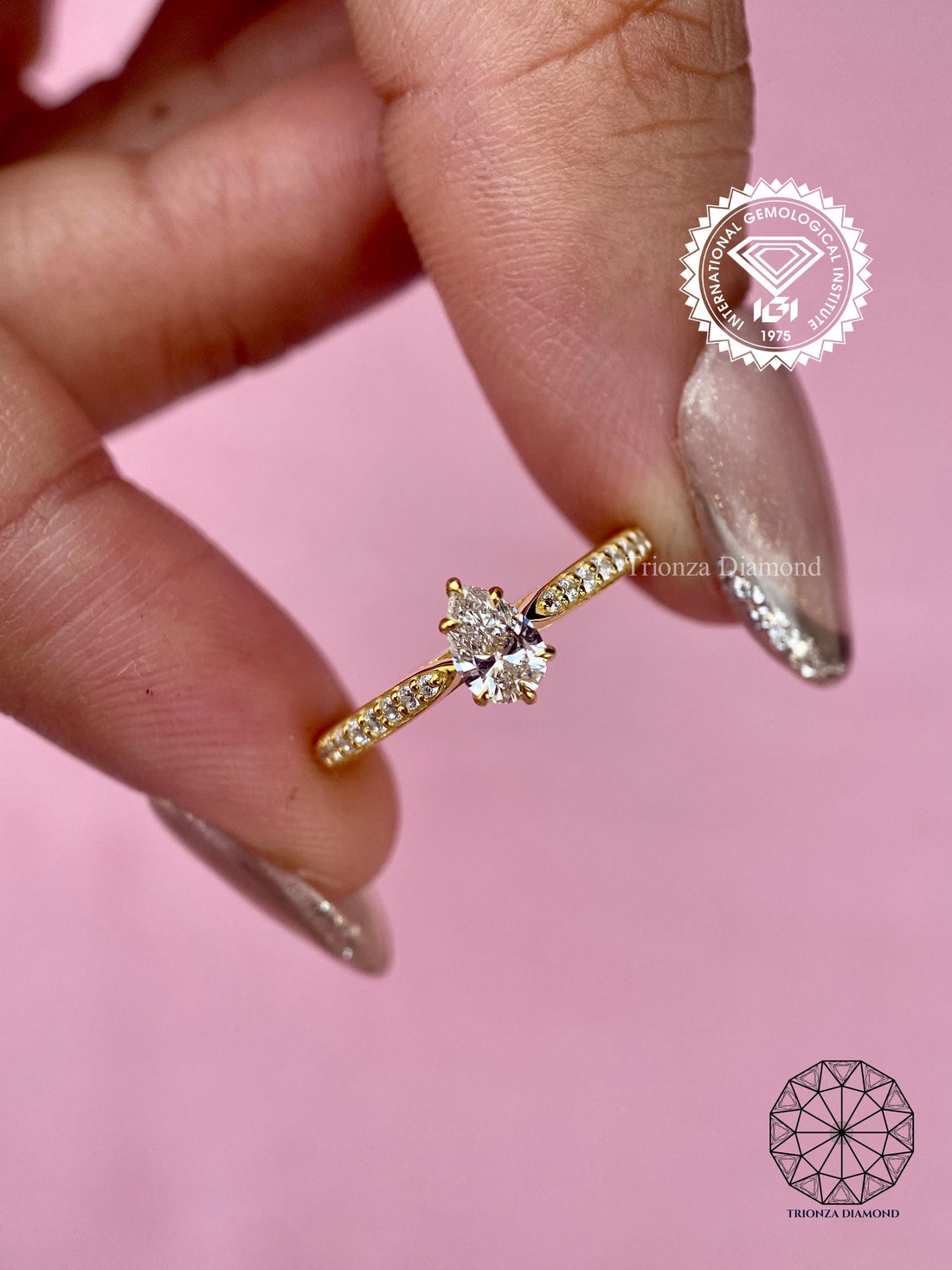 Pear cut lab grown diamond engagement ring with a six prong pave set design in white gold