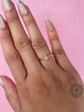 Dainty two stone ring displayed to show the emerald cut diamond measurements