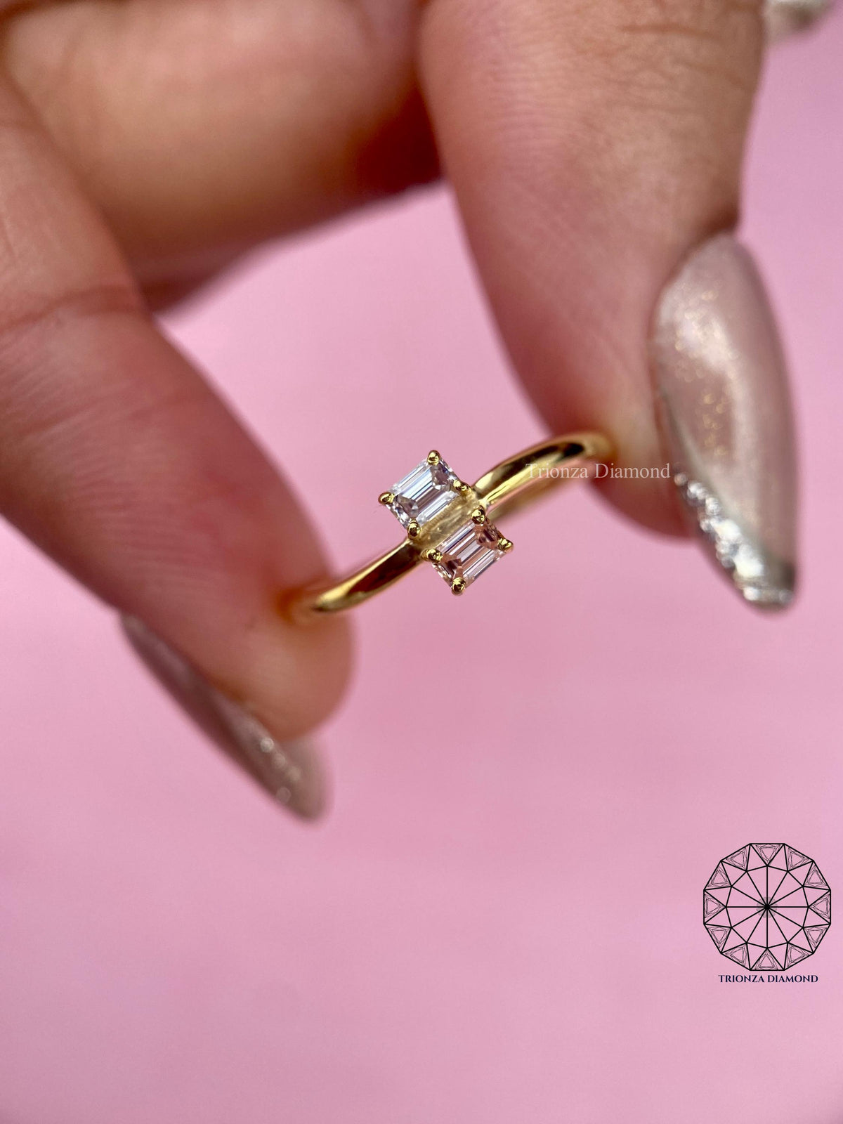 Toi et moi emerald cut ring featuring a fancy vivid pink and a white lab grown diamond