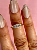Woman wearing the yellow gold baguette diamond wedding band as a promise ring