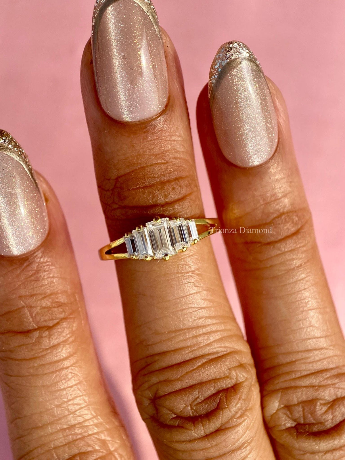 Woman wearing the yellow gold baguette diamond wedding band as a promise ring