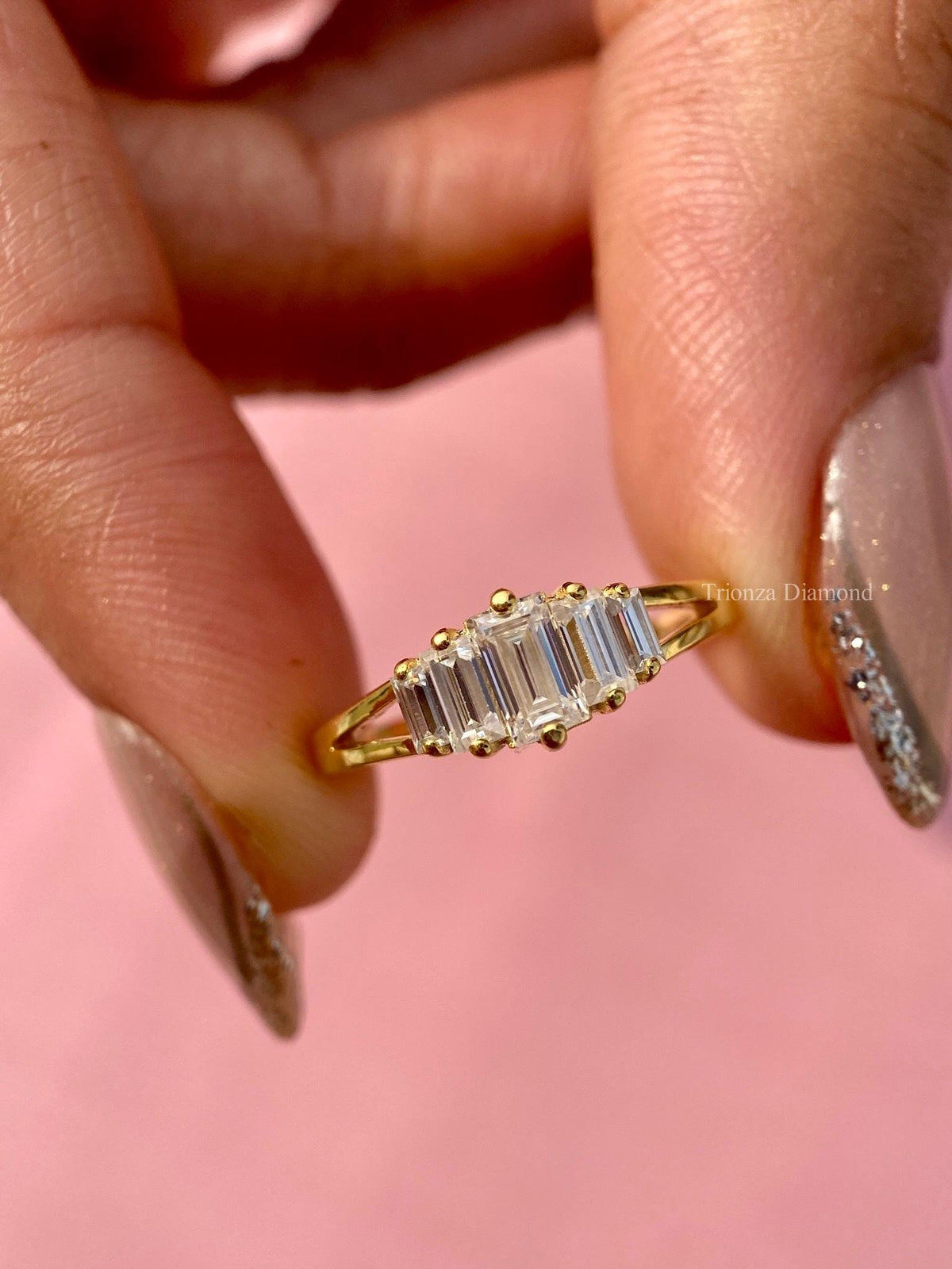 Split shank yellow gold wedding band featuring five baguette cut lab grown diamonds